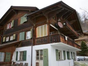 a large wooden house with a balcony at Apartment Studio Oehrli by Interhome in Gstaad