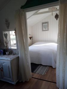 a bedroom with a white bed and a window at Rietzicht in Alkmaar
