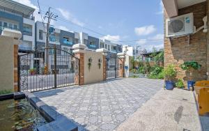 a courtyard of a building with a gate and a pond at Holby No.8 Elevator Homestay in Taitung City