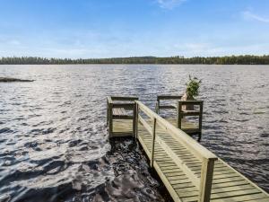 a dock on a large body of water at Holiday Home Huotarin mökki by Interhome in Tervajärvi