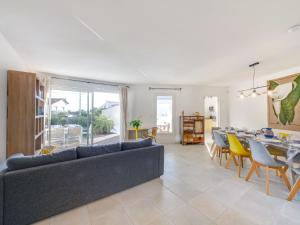 a living room with a couch and a table and chairs at Villa Villa Perdrix by Interhome in La Palud