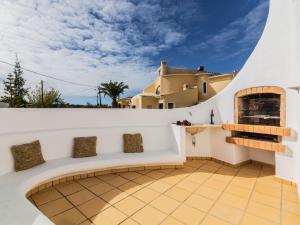 an outdoor patio with a white wall and a fireplace at Villa Arribas Villa by Interhome in Patroves