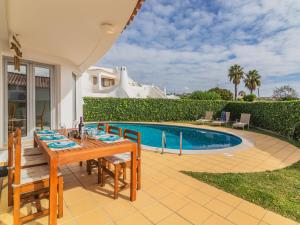 a patio with a table and chairs next to a swimming pool at Villa Arribas Villa by Interhome in Patroves