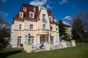 a person sitting in front of a building at Walzer Hotel in Budapest