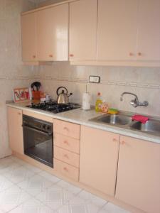 a kitchen with white cabinets and a sink at Nice double room in Alicante in Alicante