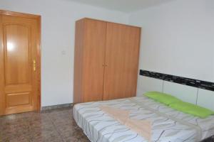 a bedroom with a bed and a wooden cabinet at Nice double room in Alicante in Alicante