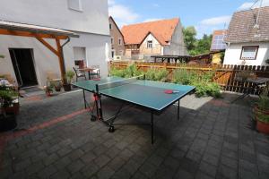 a ping pong table sitting on a patio with at Ferienwohnung Altes Rathaus in Tauberbischofsheim