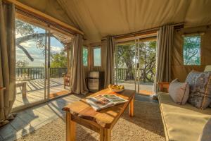 a living room with a couch and a table at Xaro Lodge in Shakawe