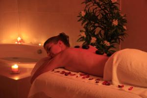 a man laying in a bed in a bath room at Boutique Hotel Kaštel, Wellness & SPA, Pet Friendly in Motovun