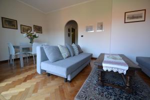 a living room with a couch and a table at Magenta Apartment in Varese