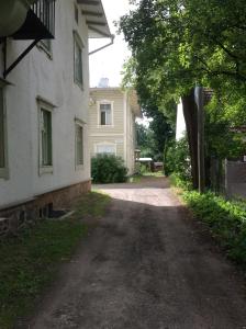 a dirt road in front of a white house at Kastani Home Accommodation in Tartu