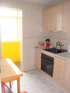 a kitchen with white cabinets and a stove top oven at Nice double room in Alicante in Alicante