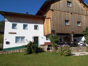 a large white building with a wooden roof at Ferienhaus Rachelblick in Kirchberg