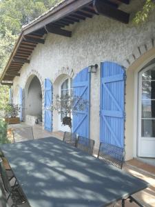 a house with blue doors on a patio at la Cigalette in Peypin