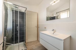 a bathroom with a glass shower and a sink at B&B Rotta Per Tavolara in Porto San Paolo