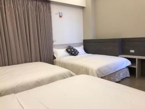 Rúm í herbergi á Good Nest Homestay