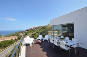 a balcony with white chairs and a table and a view at Bellavista - Ref. 029 in Begur