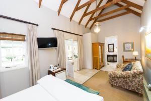 a bedroom with a bed and a couch in a room at Osborne House in Pretoria