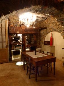 a dining room with a table and a stone wall at Soqquadro Art&Relax Alassio - Romantico Frantoio 1600 in Alassio +30 photos