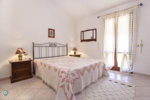 a bedroom with a bed and a dresser and a window at Villino Bordeaux in San Teodoro