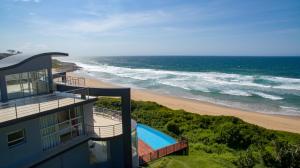 a building with a view of the ocean and a beach at Residence on Sea View in Tinley Manor