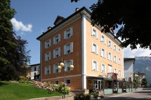 a large building on the side of a street at Hotel Terme Villa Regina in Levico Terme