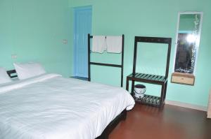 Katil atau katil-katil dalam bilik di Thanmaya Homestay
