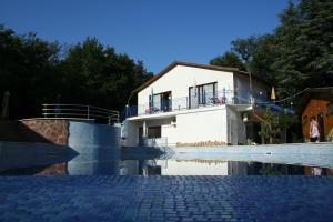 a house with a swimming pool in front of it at Oasis Villas in Golden Sands +10 photos