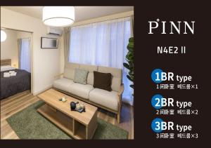 a living room with a couch and a coffee table at PINN-N4E2Ⅱ in Sapporo