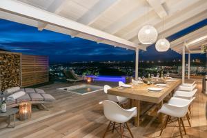 a dining room with a long table and white chairs at CM34 - Pezula Heaven On Earth in Knysna +36 photos
