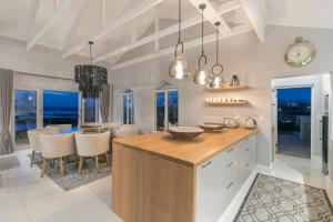 a kitchen with a table and a dining room at CM34 - Pezula Heaven On Earth in Knysna