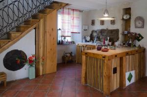a kitchen with a counter and a staircase in a room at Cocon des Cévennes - Pierre de Lune in Saint-André-de-Valborgne