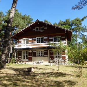 a large wooden house with trees in front of it at Large Riverside Chalet Near Gorges du Verdon in La Bastide