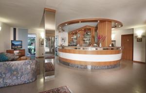 a lobby with a bar in a building at Hotel Villa Verde in Nago-Torbole