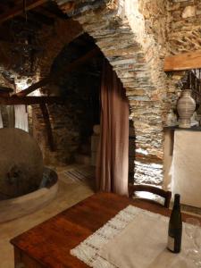 a dining room with a table and a stone wall at Soqquadro Art&Relax Alassio - Romantico Frantoio 1600 in Alassio
