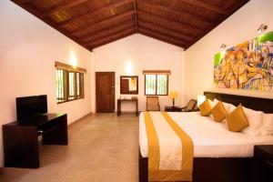 a bedroom with a bed and a television in it at Amaara Forest Hotel Sigiriya in Sigiriya