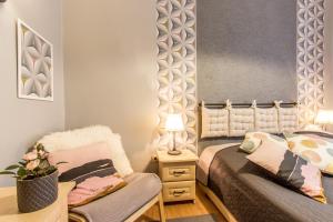 Łóżko lub łóżka w pokoju w obiekcie Apartament Bulwary Zakopane