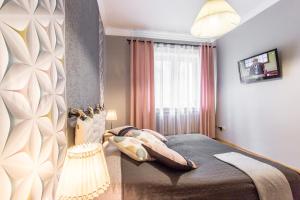 Łóżko lub łóżka w pokoju w obiekcie Apartament Bulwary Zakopane