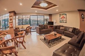 a living room with a couch and a table at The Half House by Elmar Cabin in Baguio