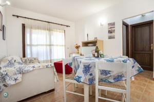 a dining room with a table and chairs at Villino Funtana Bilo in San Teodoro +14 photos
