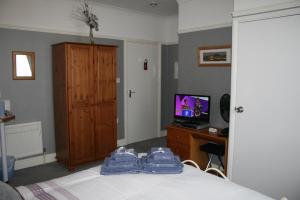 a bedroom with a bed with blue towels on it at The Ryecroft in Great Yarmouth
