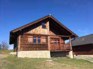 a log cabin with a porch and a deck at Chaty Lipa in Levoča