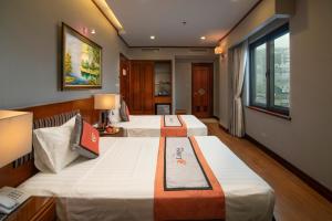 Voodi või voodid majutusasutuse Hanoi Larosa Hotel toas