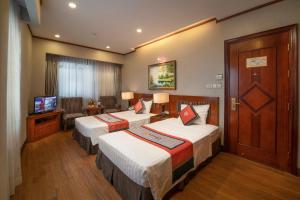 Voodi või voodid majutusasutuse Hanoi Larosa Hotel toas