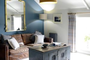 sala de estar con sofá y mesa en Cotswold Grey, en Moreton-in-Marsh