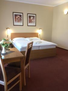 Postel nebo postele na pokoji v ubytování Hotel Roháč