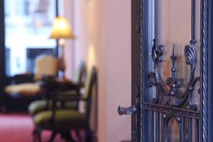 an open door to a room with chairs and a table at Angelis in Prague