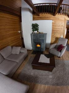 a living room with a couch and a fireplace at Kaamasen Kievari in Kaamanen