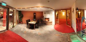 ein Wohnzimmer mit einem Tisch und einem Kamin in der Unterkunft Bavaria Lifestyle Hotel in Altötting