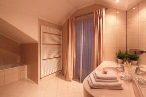 a bathroom with a tub and a sink and a shower at Angelis in Prague